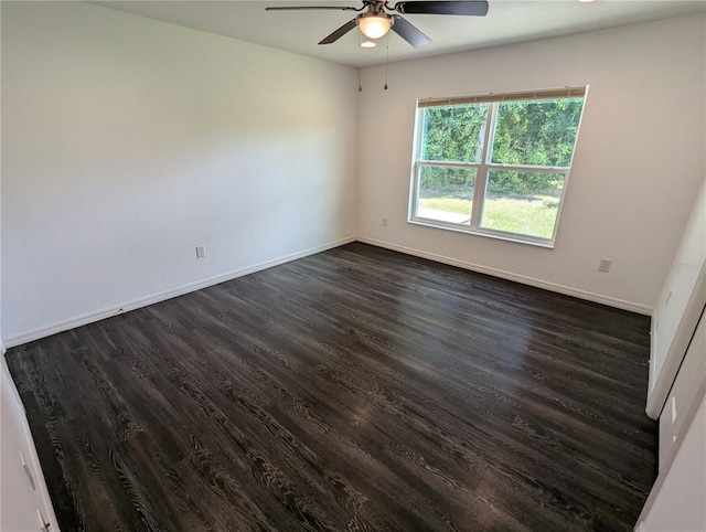 unfurnished room with dark wood-type flooring and ceiling fan