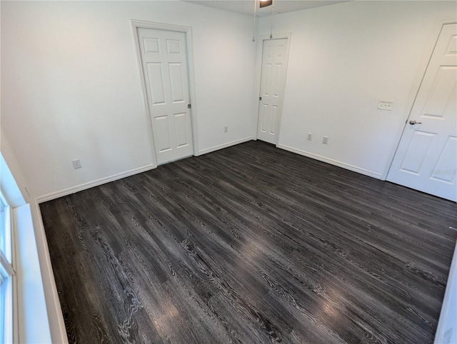 empty room with ceiling fan and dark hardwood / wood-style floors