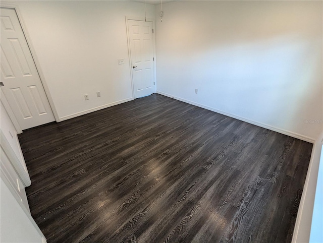 empty room featuring dark wood-type flooring