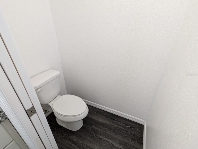 bathroom with toilet and hardwood / wood-style flooring