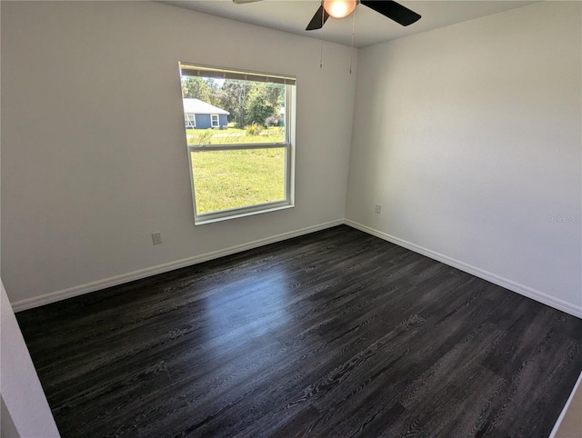 spare room with dark wood-type flooring and ceiling fan