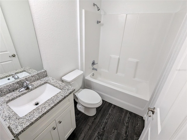 full bathroom with vanity, toilet, bathtub / shower combination, and wood-type flooring