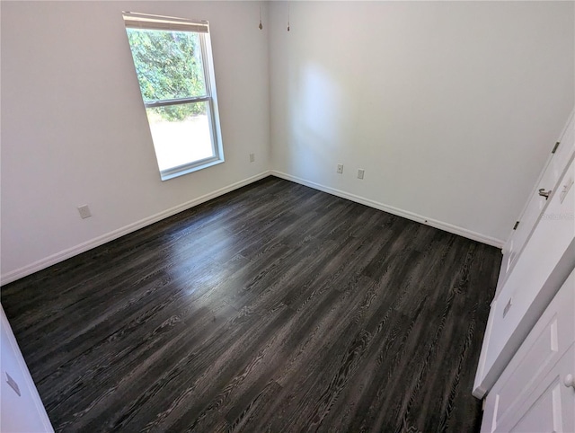 empty room featuring dark hardwood / wood-style flooring