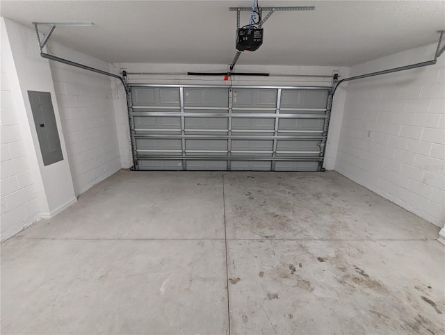 garage with a garage door opener and electric panel