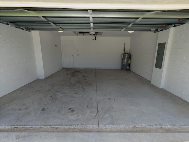 garage featuring electric panel and water heater