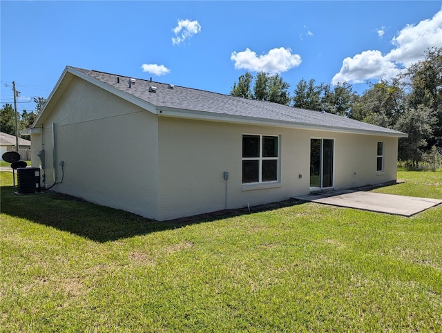 back of house with a patio area, a yard, and central AC