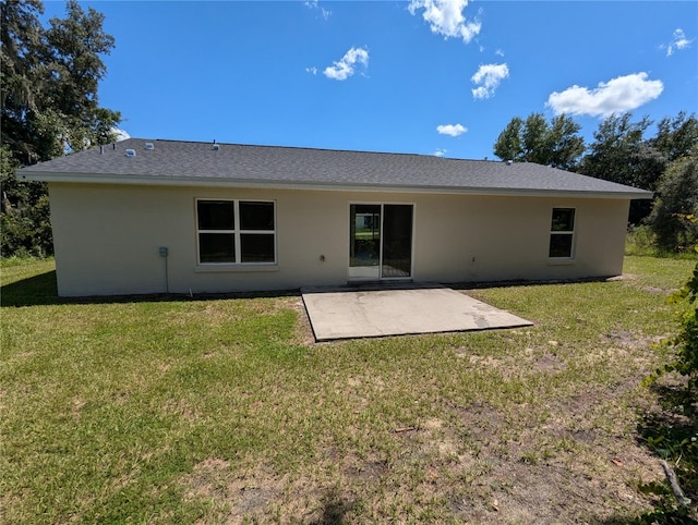 back of house with a patio area and a yard