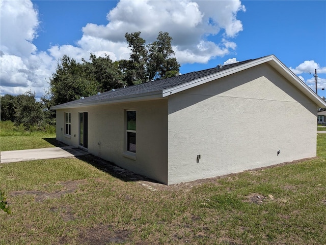 view of home's exterior with a patio area and a lawn