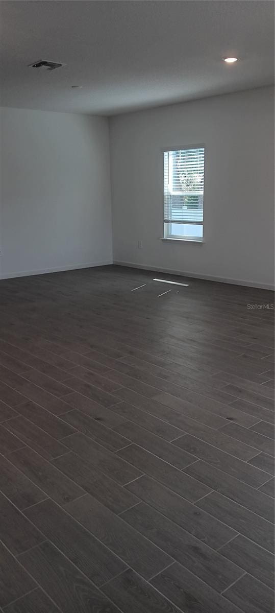 spare room featuring dark hardwood / wood-style flooring