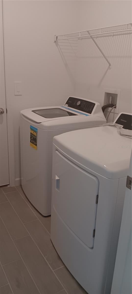 washroom featuring tile patterned floors and washing machine and dryer