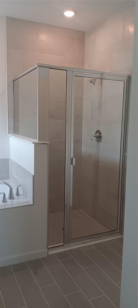 bathroom with shower with separate bathtub