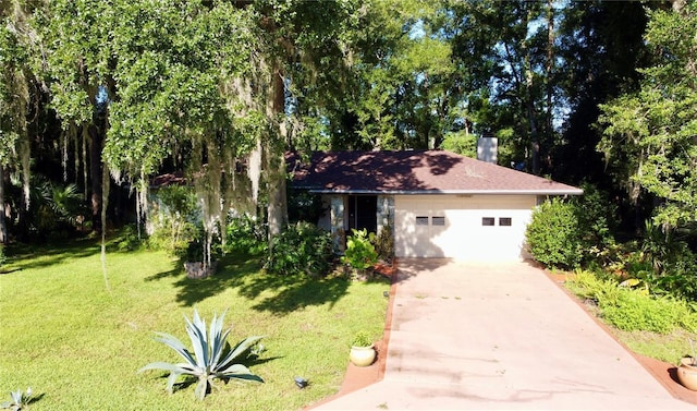 ranch-style house with driveway, a garage, and a front lawn