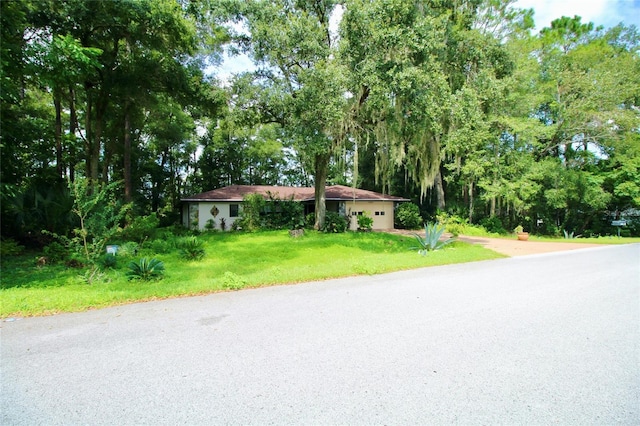 view of front facade with an attached garage and a front lawn