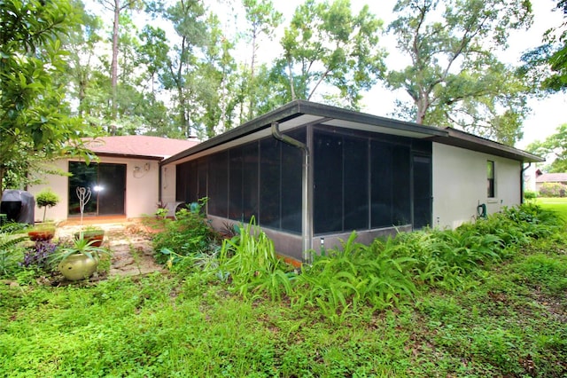 view of side of home with a sunroom