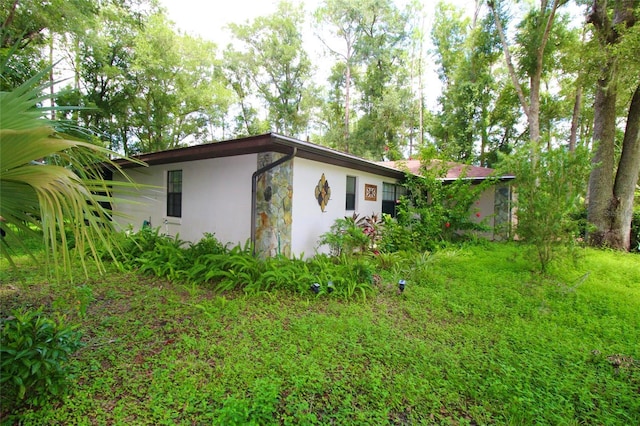 view of side of property with stone siding and stucco siding