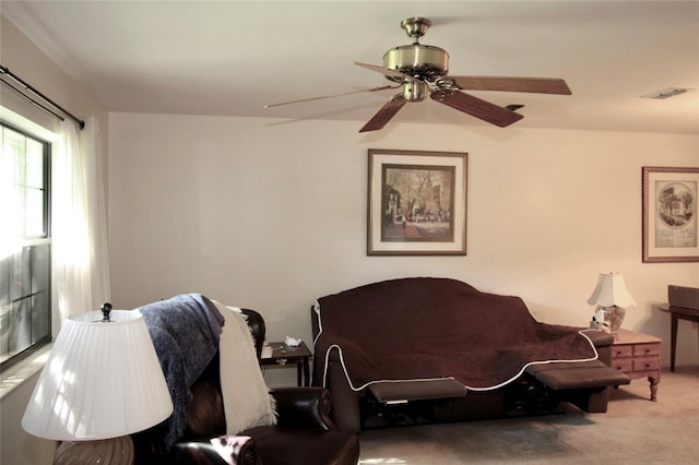 carpeted living room featuring ceiling fan