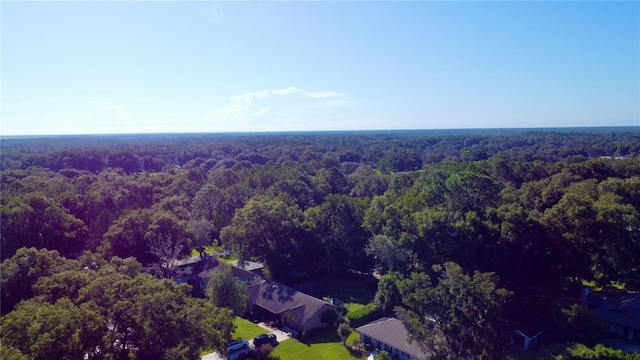 drone / aerial view featuring a view of trees