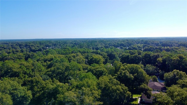 drone / aerial view featuring a forest view