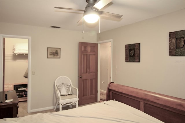 carpeted bedroom featuring a closet, visible vents, a spacious closet, ceiling fan, and baseboards