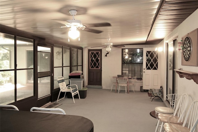 sunroom / solarium featuring ceiling fan