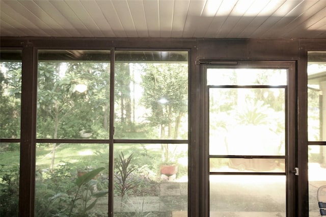 unfurnished sunroom featuring wood ceiling