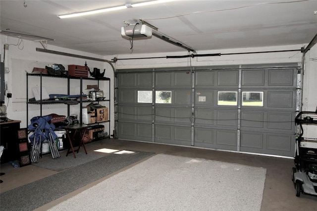 garage with electric panel and a garage door opener