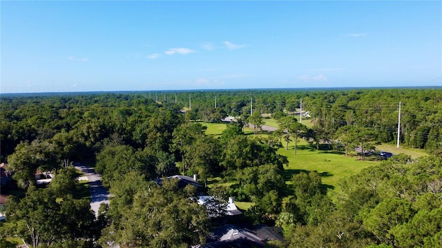 birds eye view of property featuring a wooded view