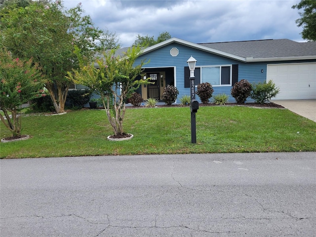 ranch-style house featuring a garage and a front yard