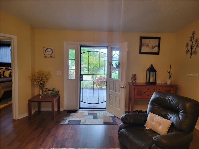 foyer featuring dark hardwood / wood-style flooring and a textured ceiling