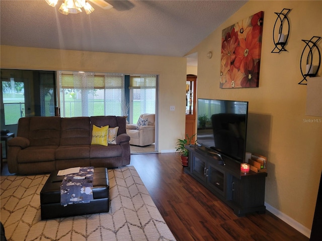 living room featuring a textured ceiling, ceiling fan, and dark hardwood / wood-style floors