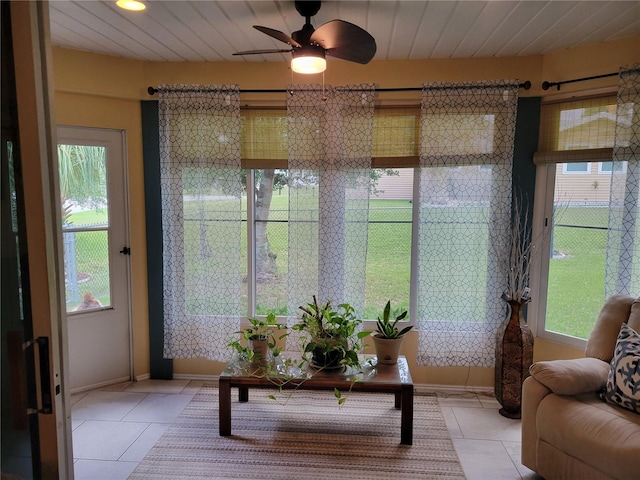 sunroom / solarium featuring ceiling fan