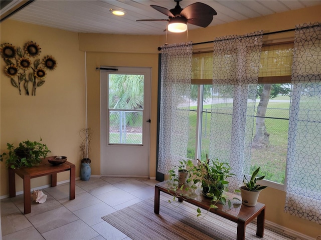 sunroom / solarium featuring ceiling fan