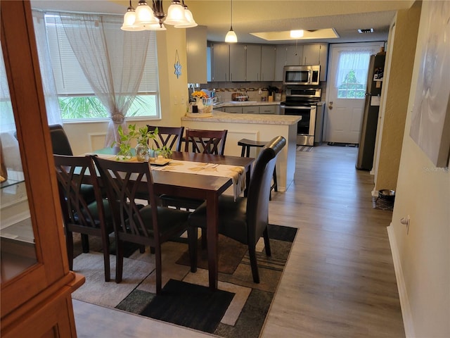 dining space featuring wood-type flooring