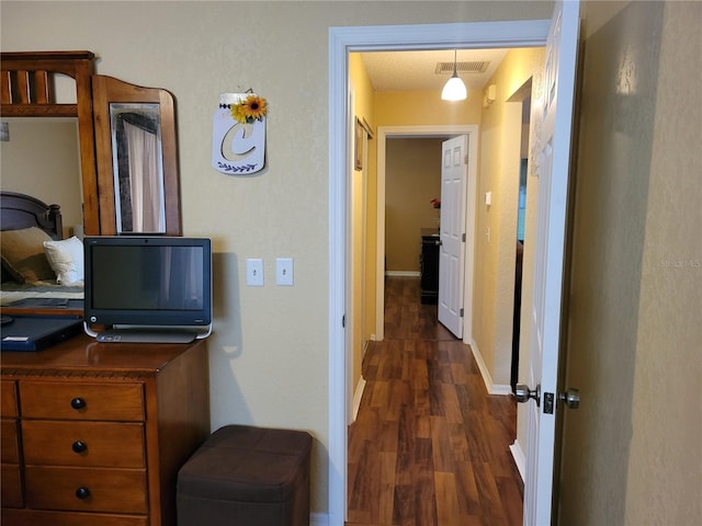 hallway featuring dark hardwood / wood-style flooring