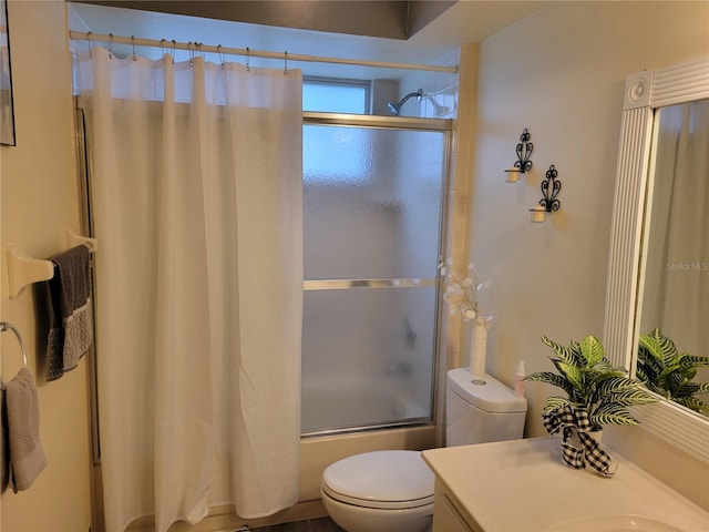 full bathroom featuring toilet, vanity, and combined bath / shower with glass door