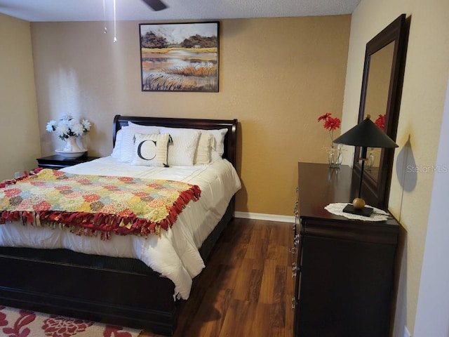 bedroom featuring dark hardwood / wood-style flooring and ceiling fan