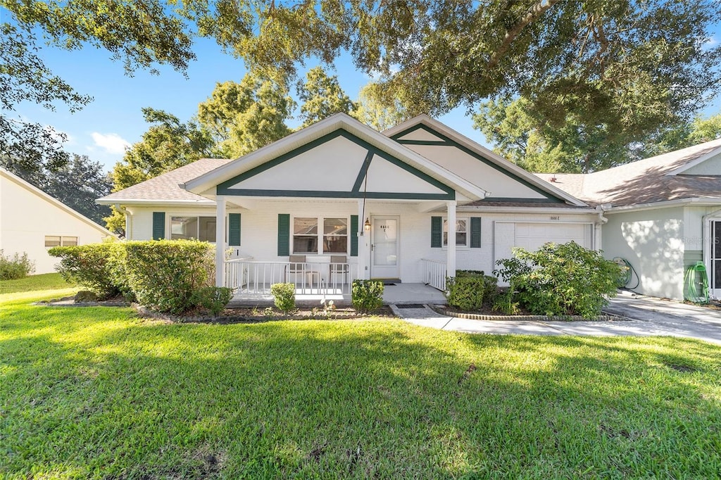 view of front of home with a front yard and covered porch