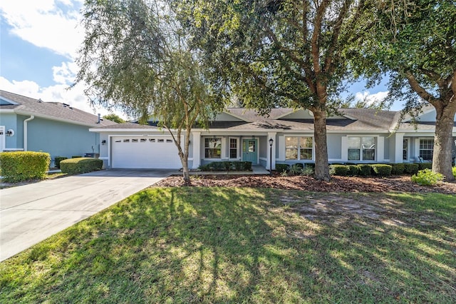 ranch-style house featuring a front yard and a garage