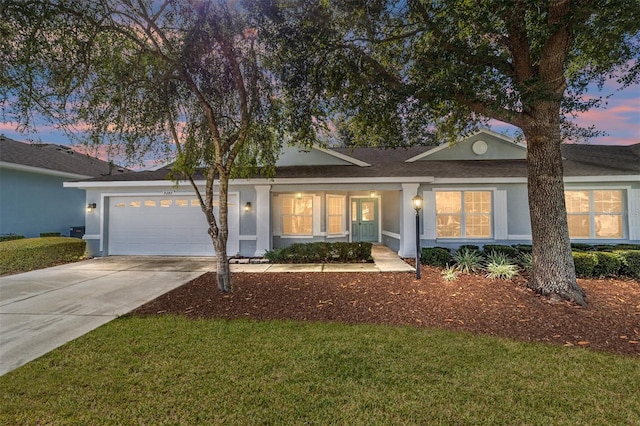 ranch-style home with a yard and a garage