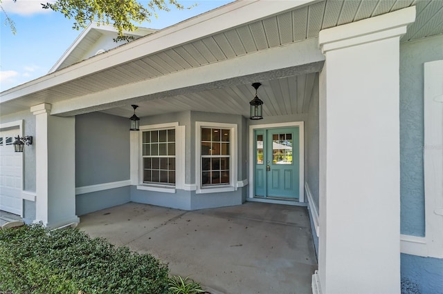 doorway to property featuring a garage and covered porch