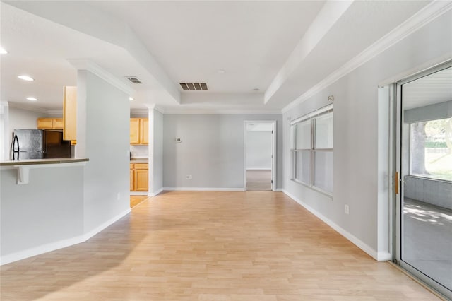 unfurnished living room with ornamental molding and light hardwood / wood-style floors