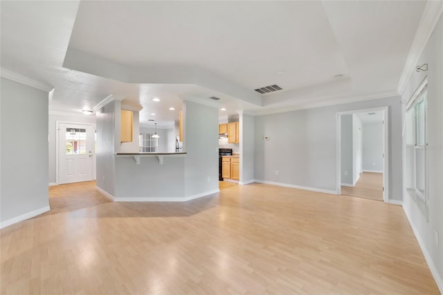 unfurnished living room featuring ornamental molding and light hardwood / wood-style floors