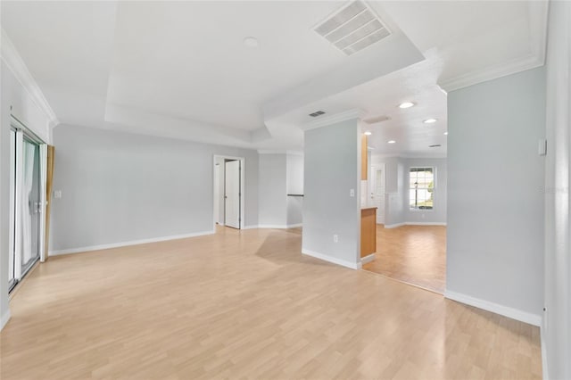 unfurnished living room featuring ornamental molding and light wood-type flooring