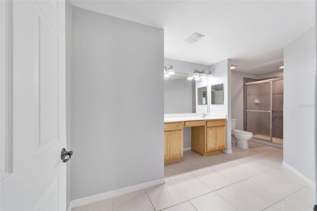 bathroom with vanity, toilet, an enclosed shower, and tile patterned floors