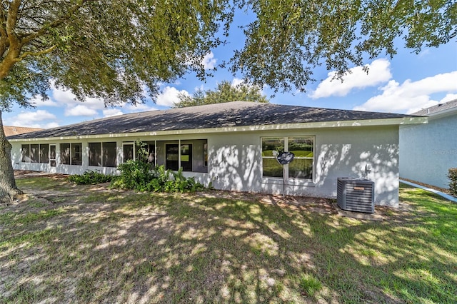 back of property featuring a yard and central AC unit