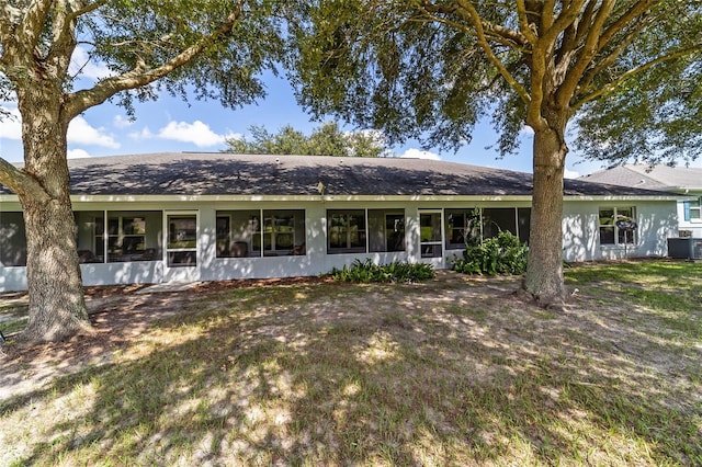 view of front facade featuring a sunroom and central air condition unit