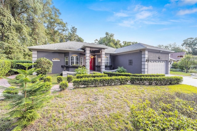 view of front of house featuring a front yard and a garage