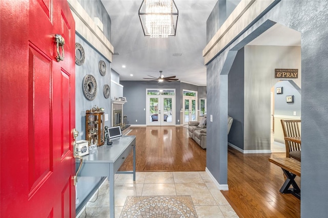 entrance foyer with french doors, ceiling fan, and light hardwood / wood-style flooring