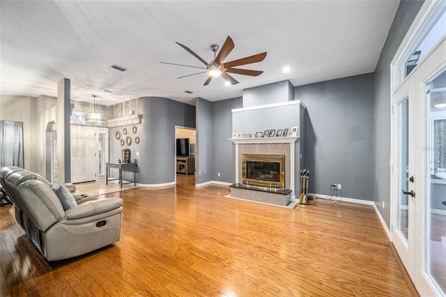 living room with ceiling fan and wood-type flooring