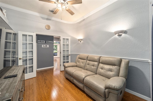 living room with ornamental molding, french doors, hardwood / wood-style floors, and ceiling fan